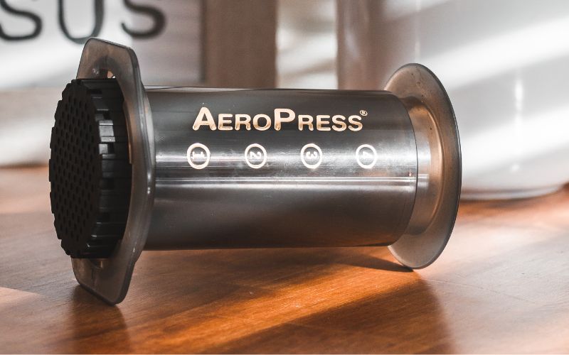 An AeroPress brewer shown in the 'inverted' (upside-down) position, ready for brewing.